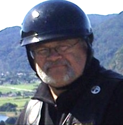 Pastor bob in a helmet in front of mountains