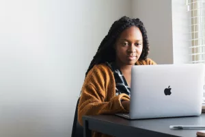 Woman typing on a Macbook