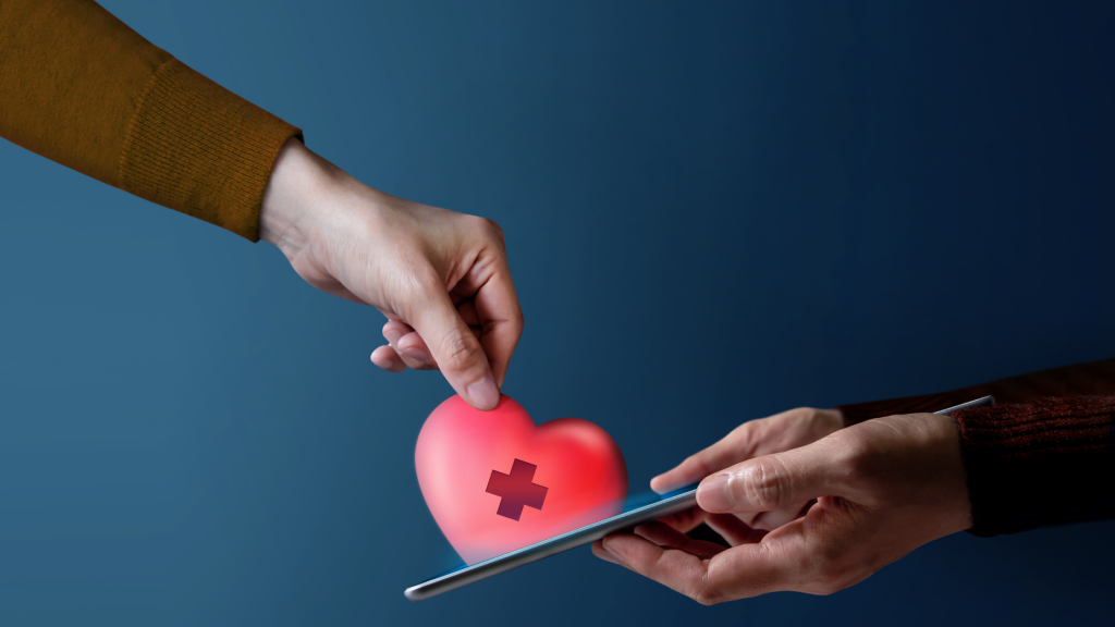 Hand holding a heart on a mobile phone