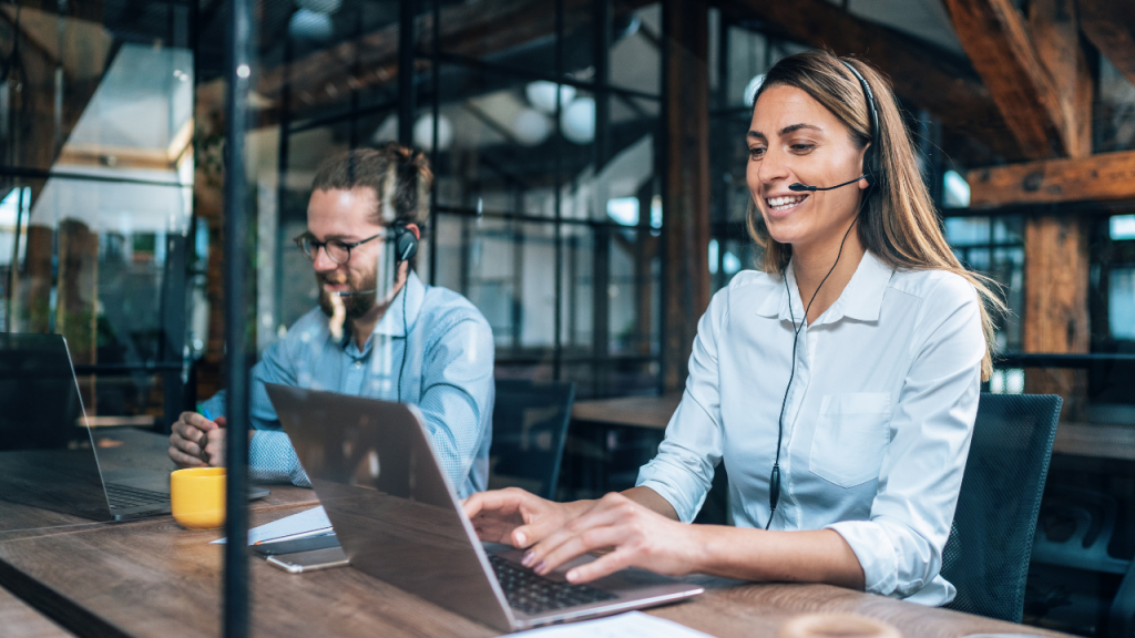 man and woman on laptop withe headset mic