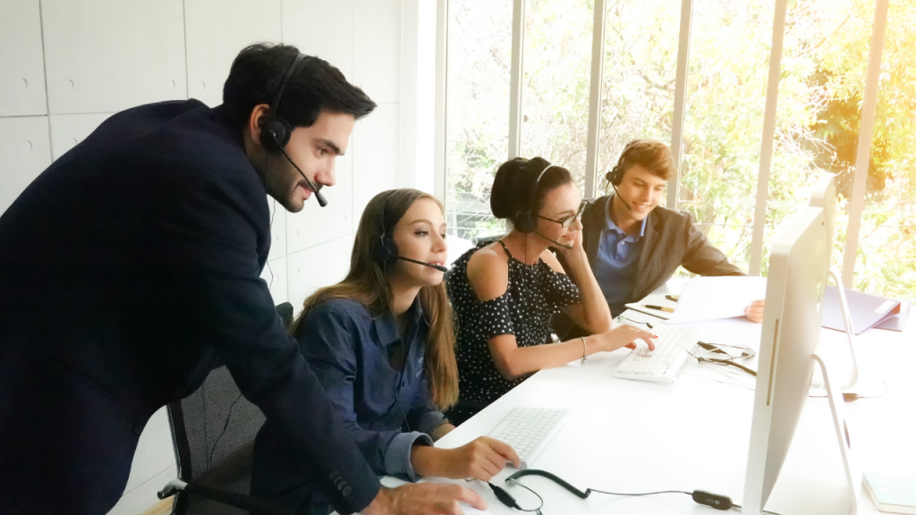 people with headset looking at computer