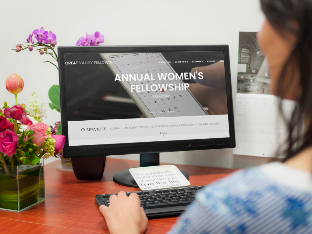 woman on computer with flowers on the table