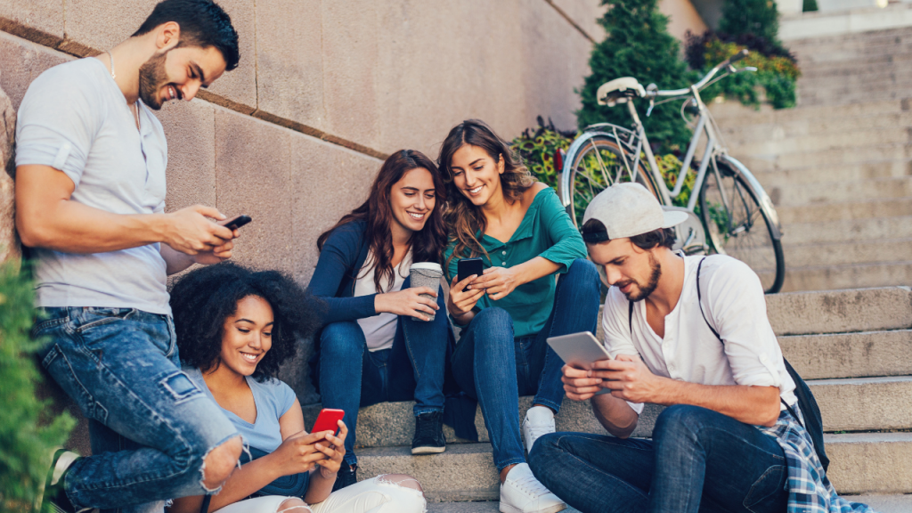 people smiling while looking at their phone