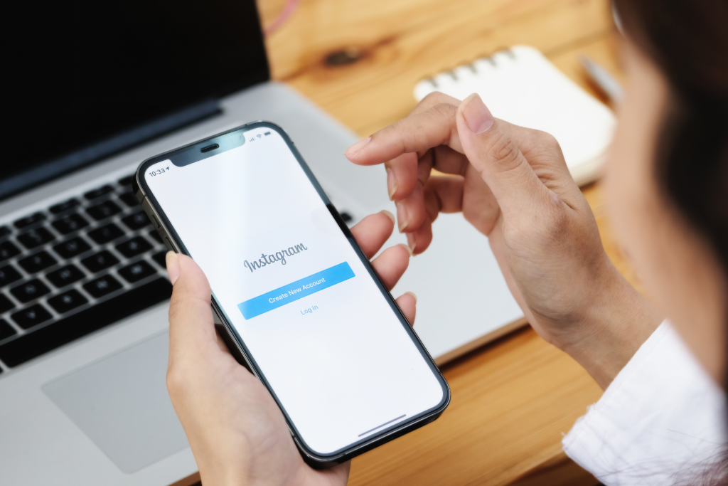 Woman Holding Smartphone with Instagram Application on the Screen