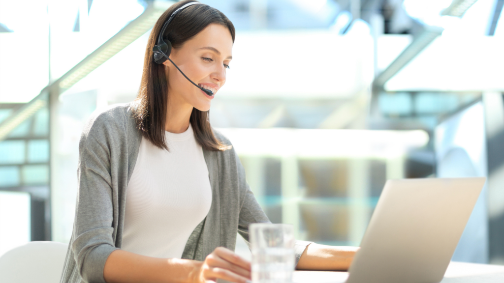 customer support woman on headphones and on laptop