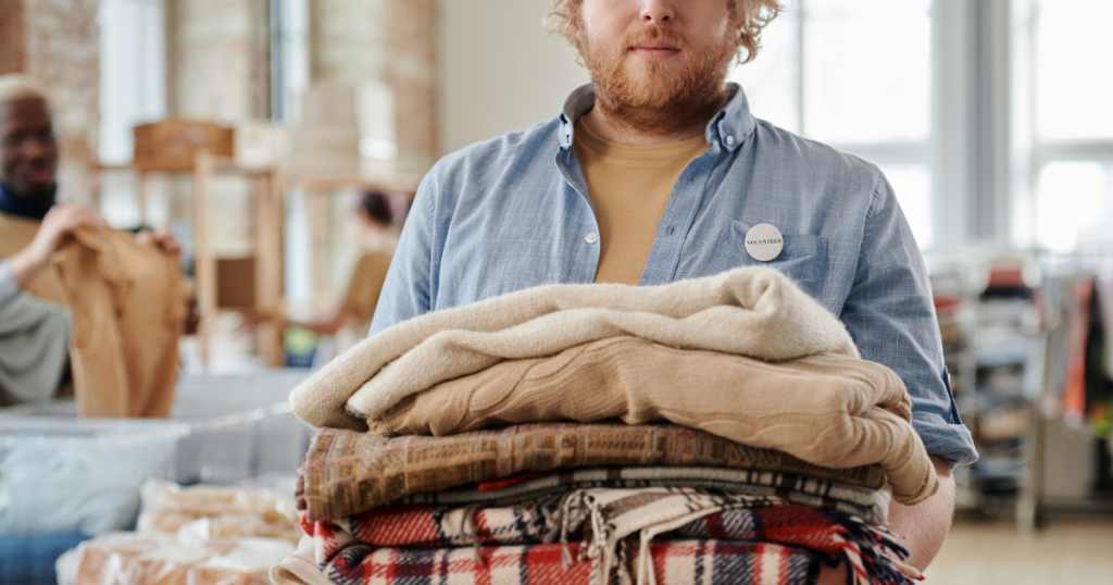 A man holding blankets.