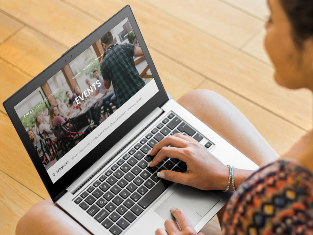 Young woman using laptop on wooden floor