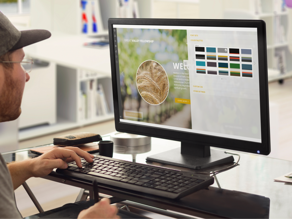 person working on the computer with left hand on the keyboard