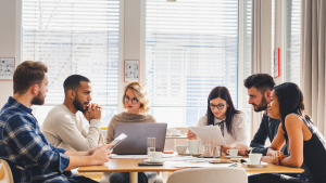people meeting with laptop on table