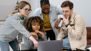 Group of People Planning while Looking at the Laptop