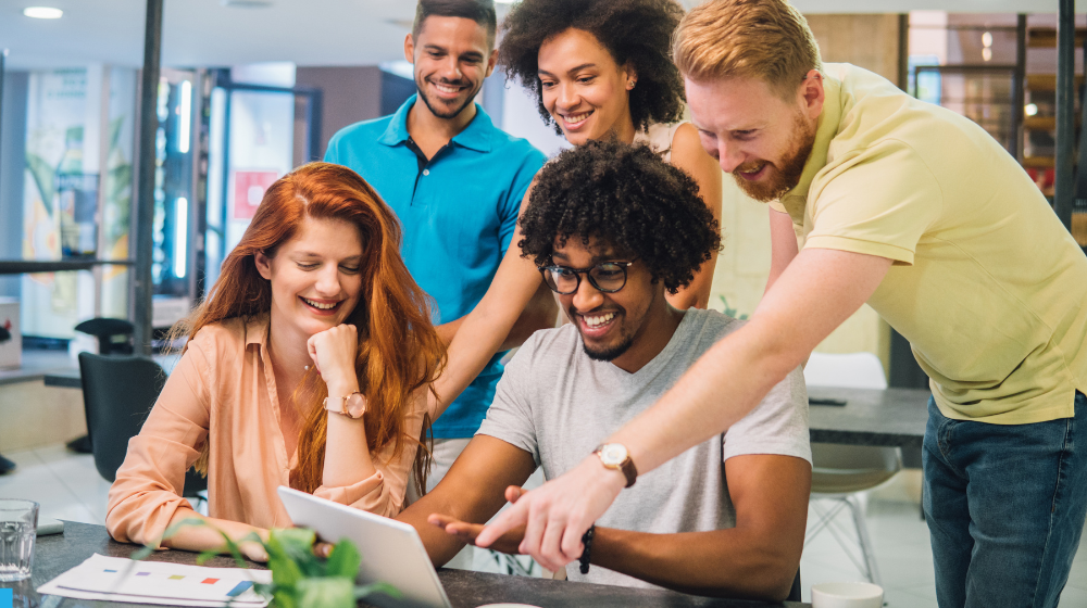 Young people gathered around digital tablet