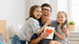 kids giving letter to father