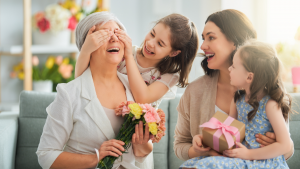 grandkids surprises grandmother with gift and flowers