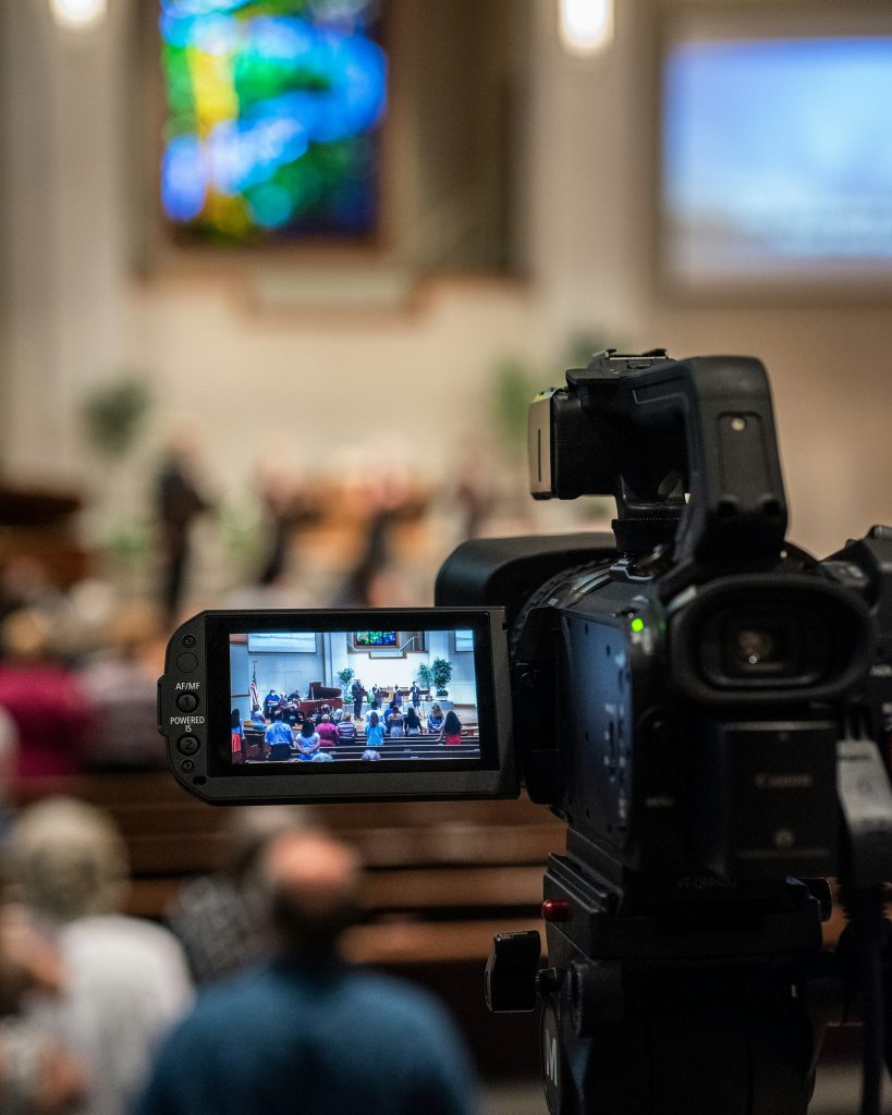 video camera with church service on screen