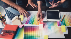 Hands of Designers Discussing over Color Palettes