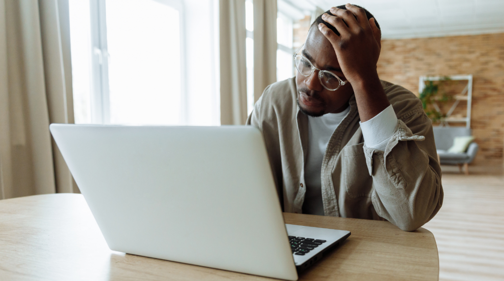 Man Using Laptop Looking Problematic