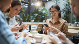 Group of People on Their Phones at a Cafe