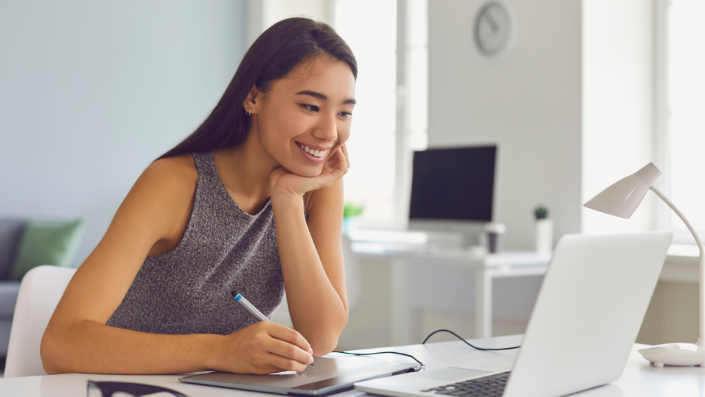 Happy Young Girl Working on Design Project Using Modern Graphic Tablet and Laptop Computer