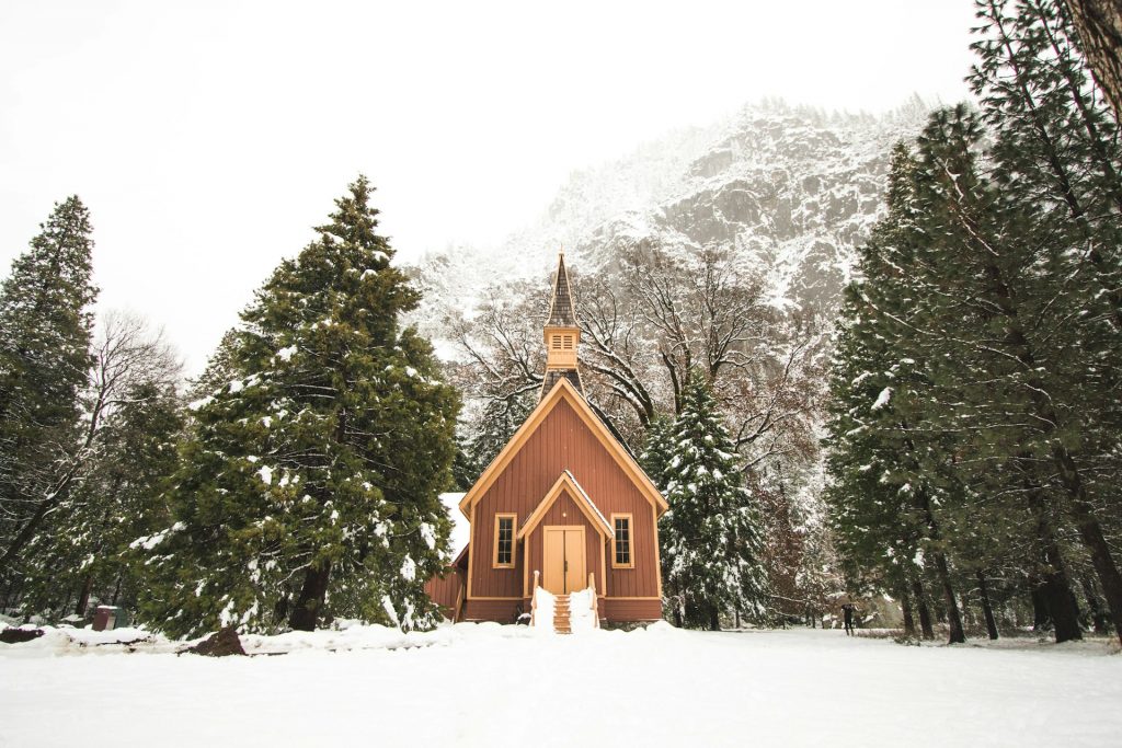 A church building with snowy landscape surrounding it
