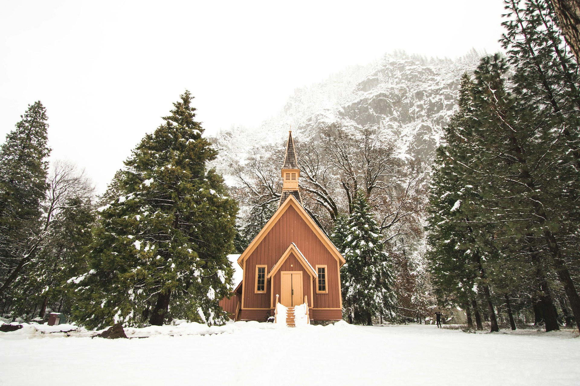 A church building with snowy landscape surrounding it